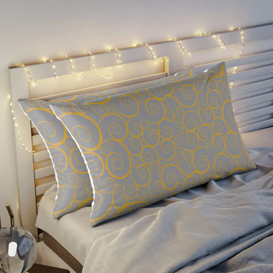 Decorative pillow with swirl pattern on bed, fairy lights overhead.