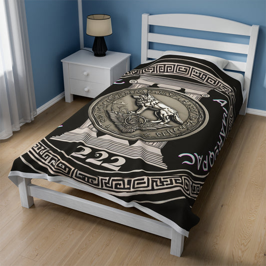 Bed with black and gold Aztec-inspired patterned comforter in blue room.