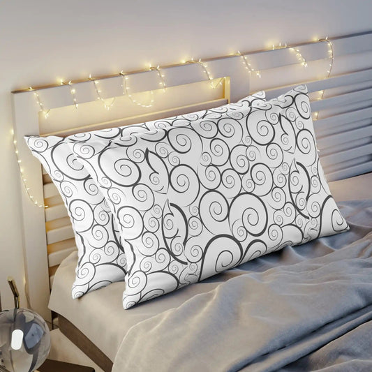 Patterned pillow on bed with twinkling string lights and headboard.