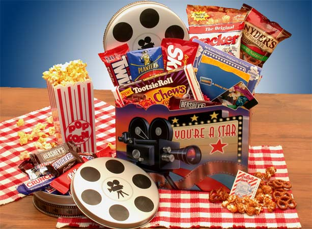 Movie-themed gift basket with popcorn, candy, and film reels.