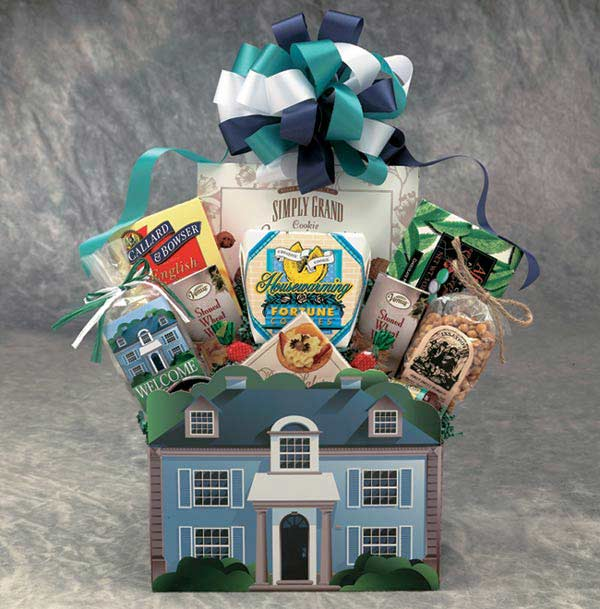 Gift basket with cookies and snacks in house-shaped packaging with bow.