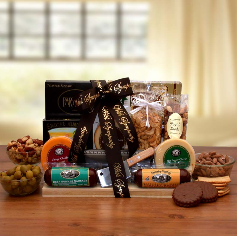 Gourmet food gift basket with cheese, sausage, nuts, and chocolates.