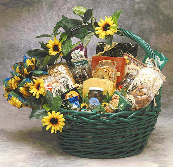 Green basket filled with assorted gourmet foods and sunflowers.