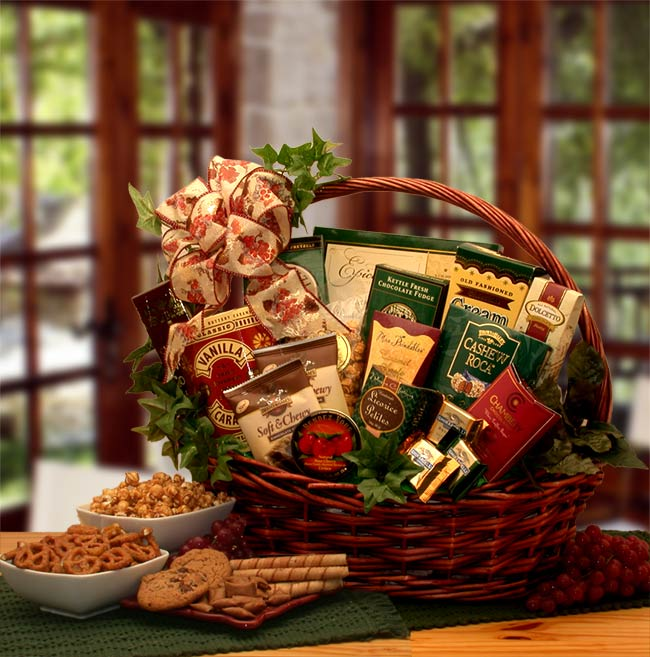 Gourmet food gift basket with assorted treats on wooden table.