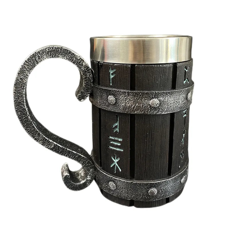 Metal mug with ornate handle and etched rune-like patterns.