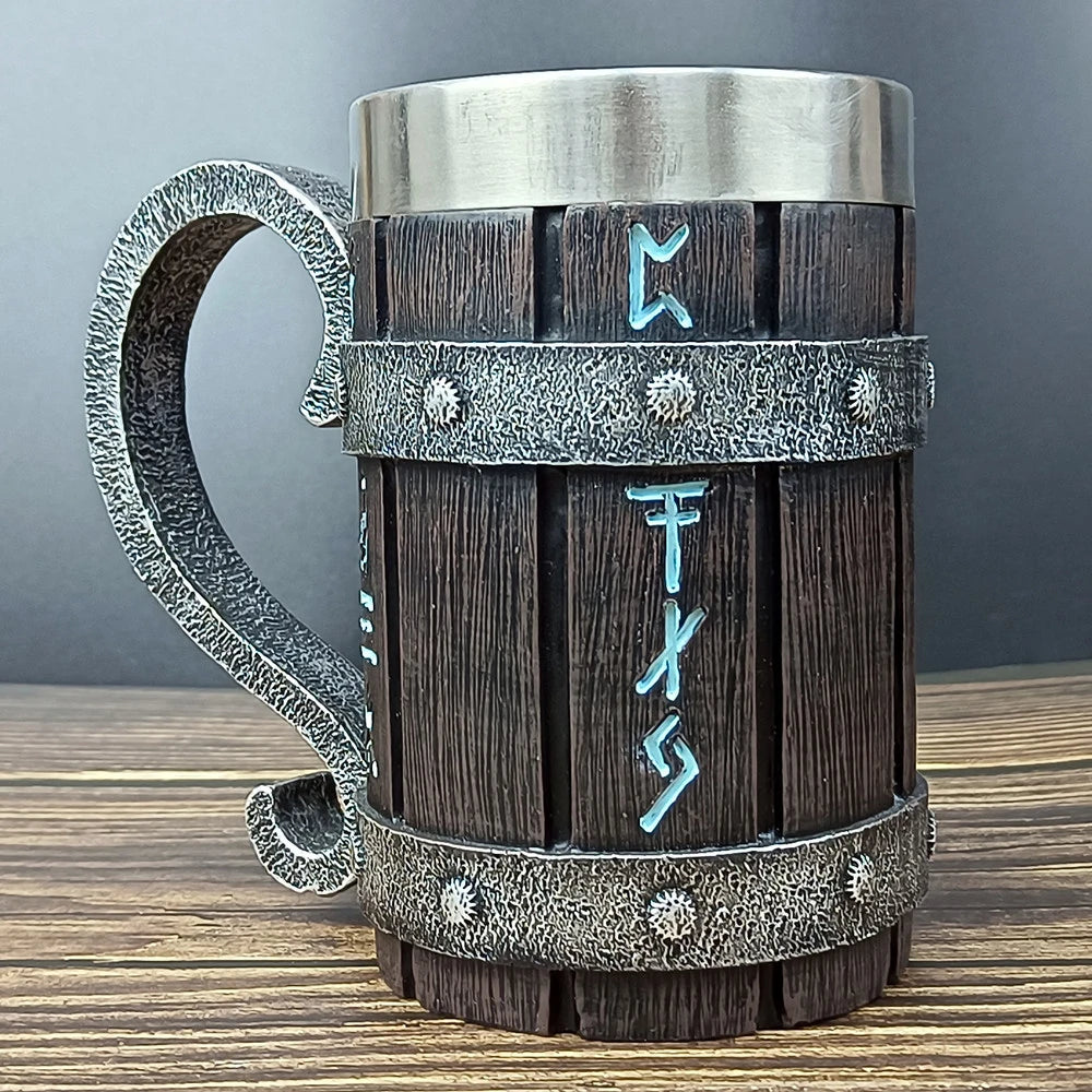 Wooden barrel-shaped mug with metal accents and runes on table.